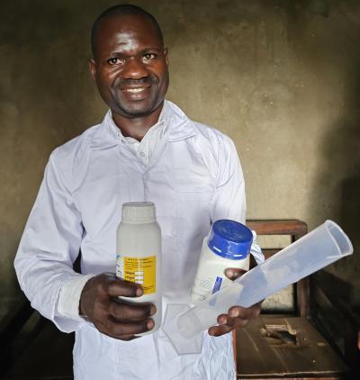 Laboratory technician with some of the supplied reagents